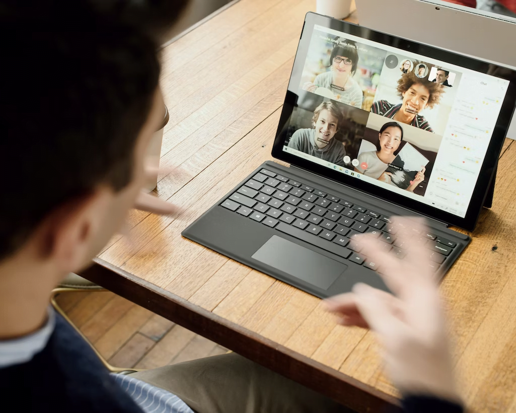 a person talking to a group of people on a laptop