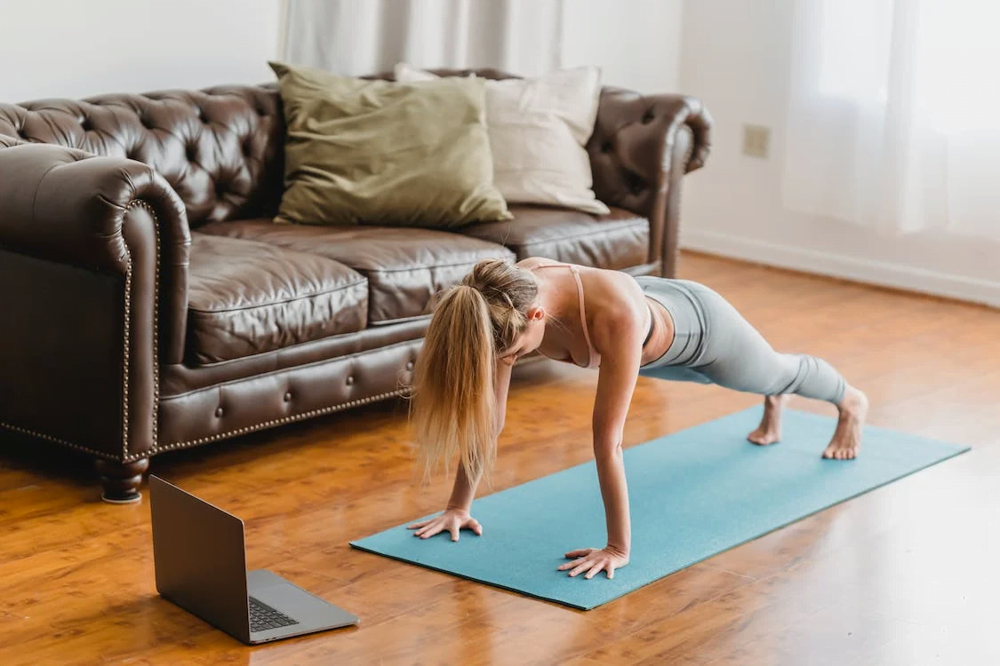 a woman planking on a mat