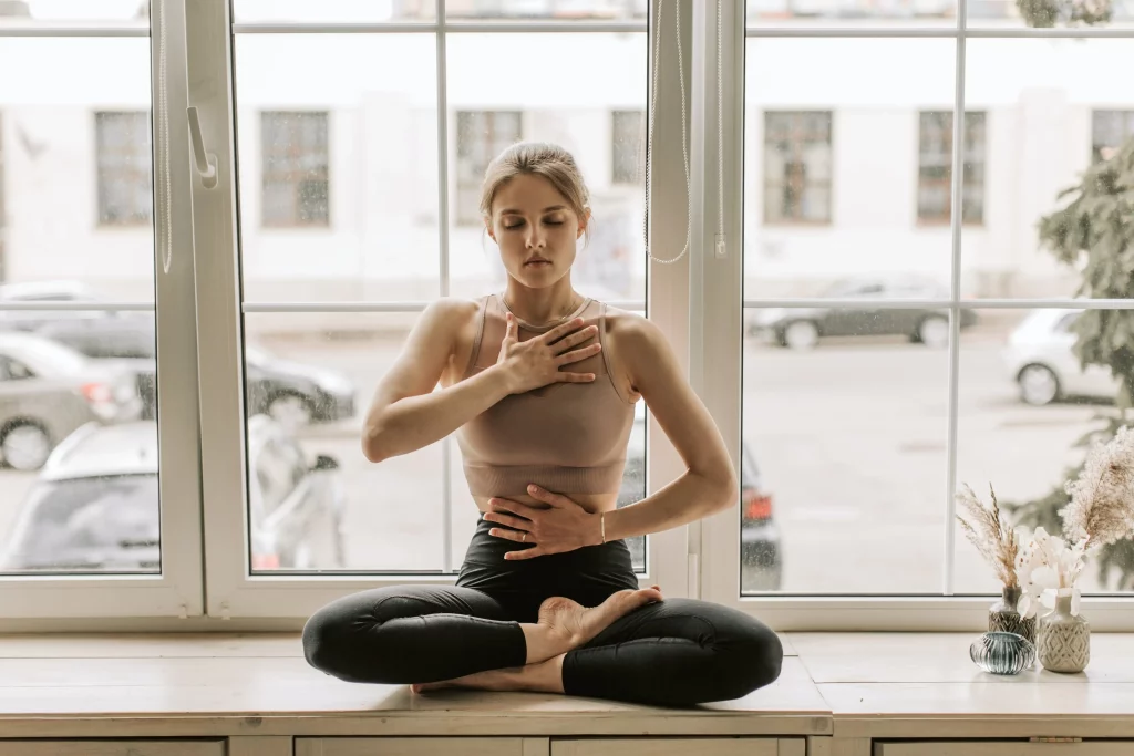 a woman in black leggings doing meditation
