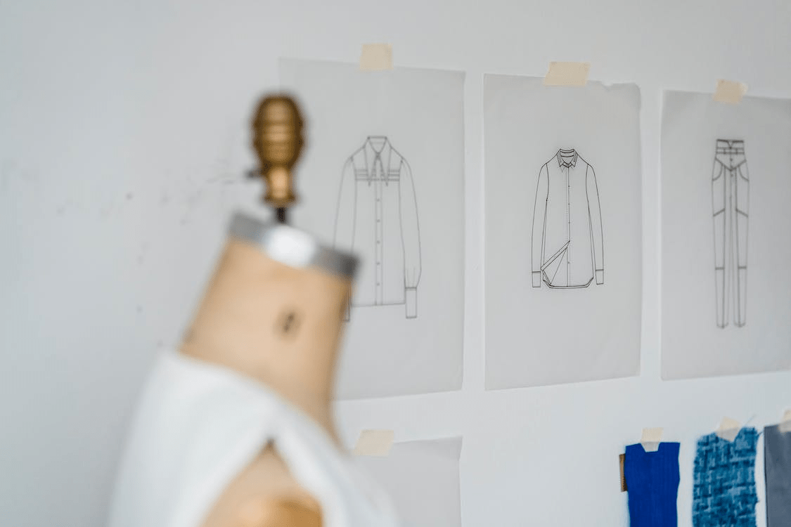 mannequin near wall with clothes sketches
