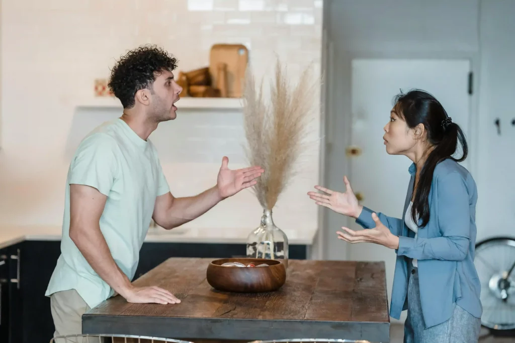 a man and woman having a heated argument in a kitchen