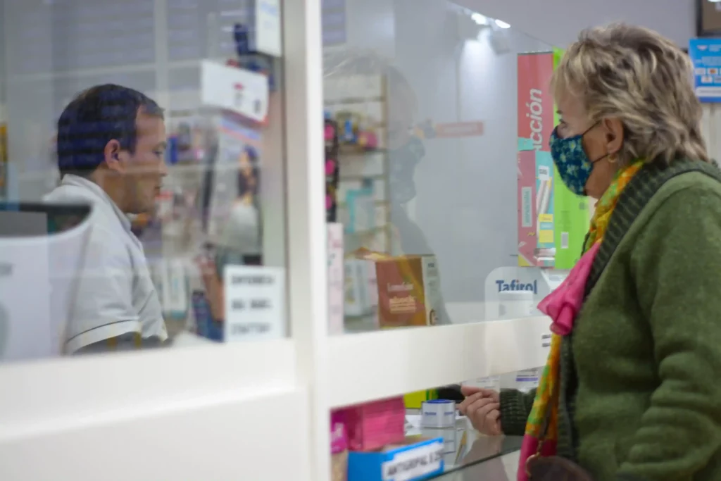 image of patient and community pharmacist at pharmacy